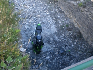 My brother low sides and his bike ends up down a storm drain!